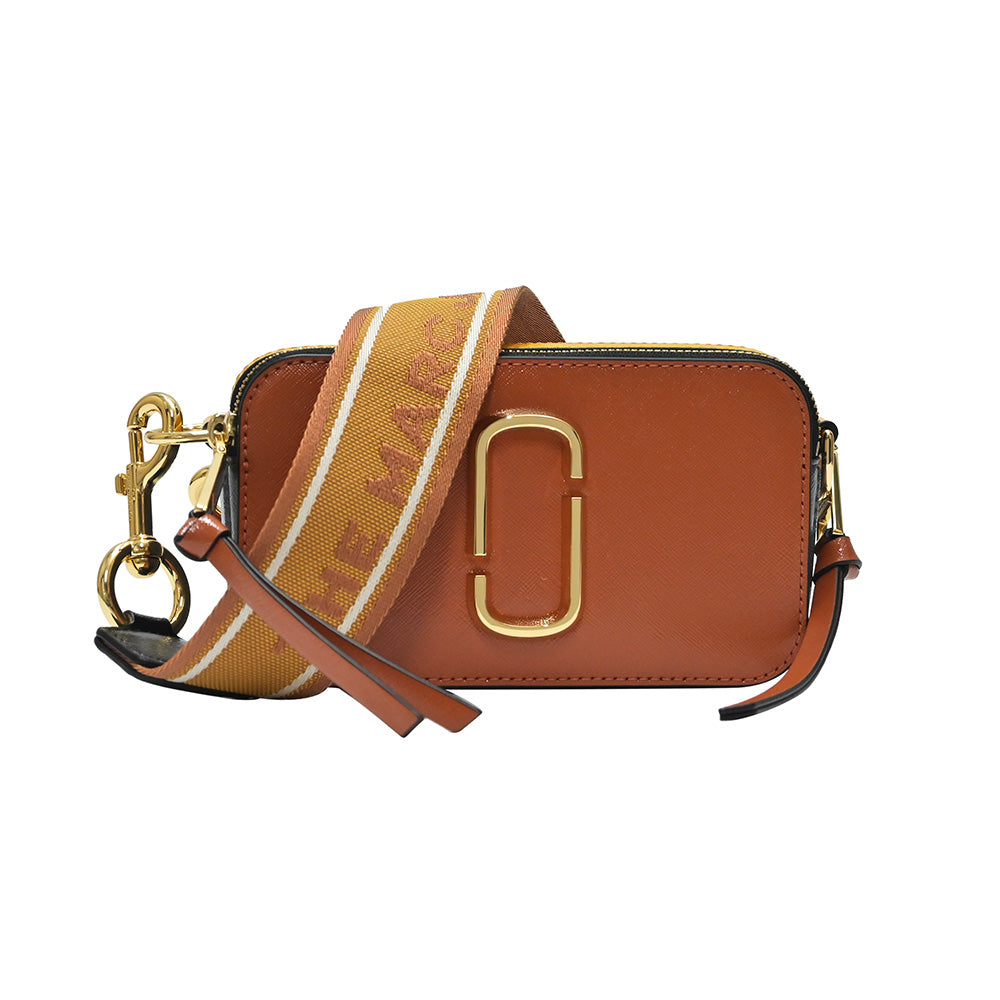 The Logo Strap Snapshot bag in brown